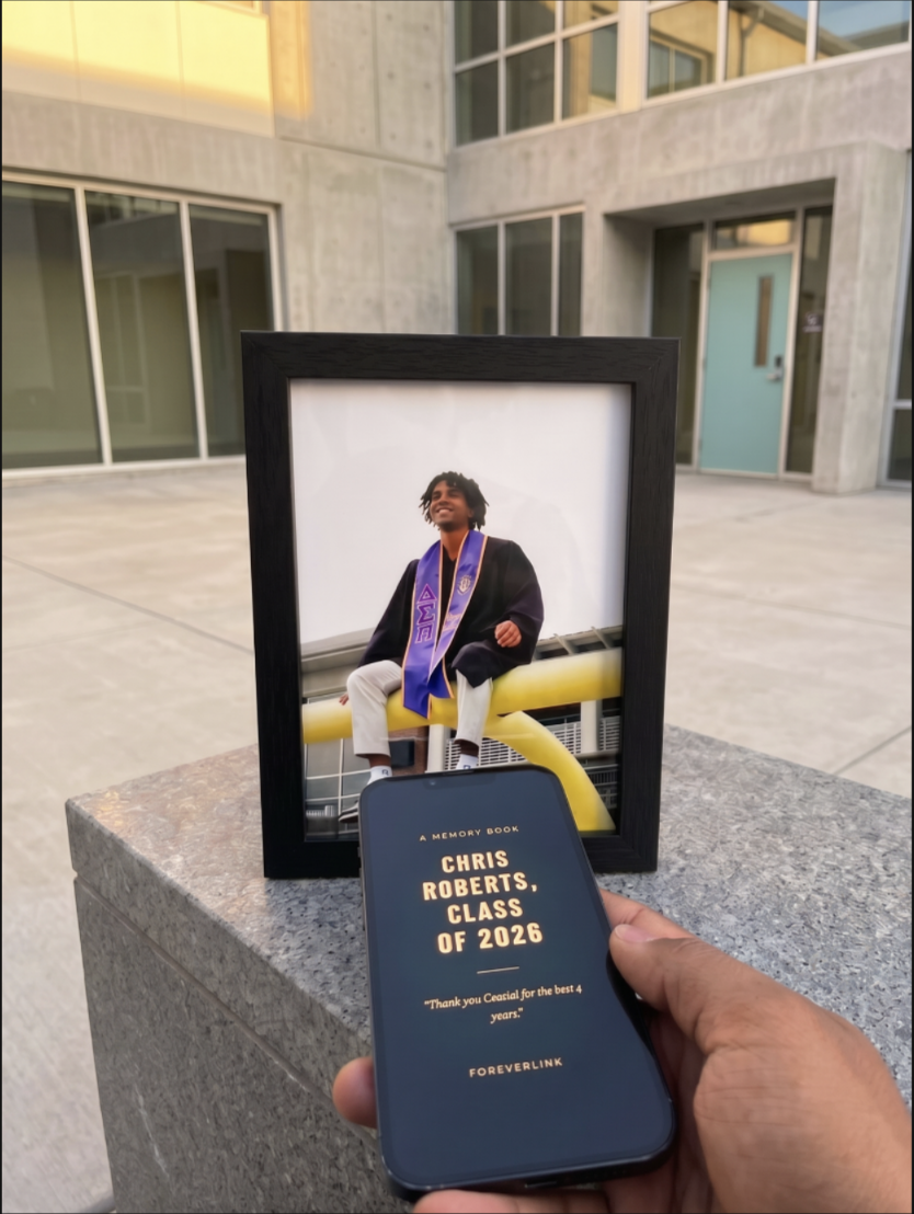 ForeverLink framed graduation photo with phone showing the memory book